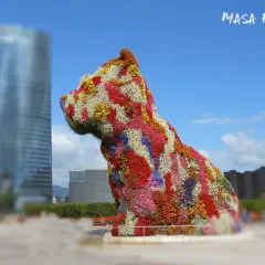 Kwiatowy pies w Bilbao, największym mieście kraju Basków, na tle nowoczesnej architektury.